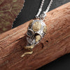 Snake entwined skull necklace